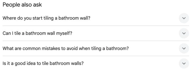 A Google People also ask box with four expandable questions about tiling a bathroom wall, a search results feature
